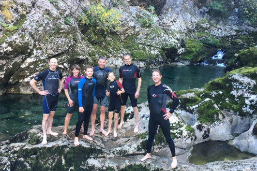 Family on an activity holiday swimming in rock pools near Lake Skadar in Montenegro