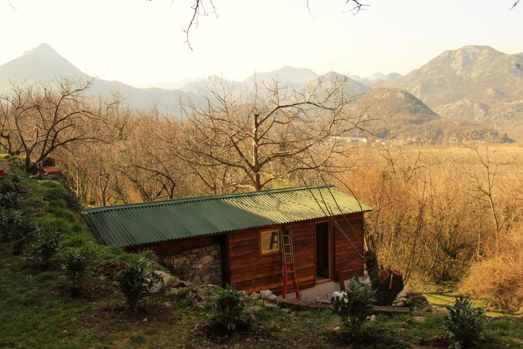 Self-constructed eco-cabin looking out over a valley