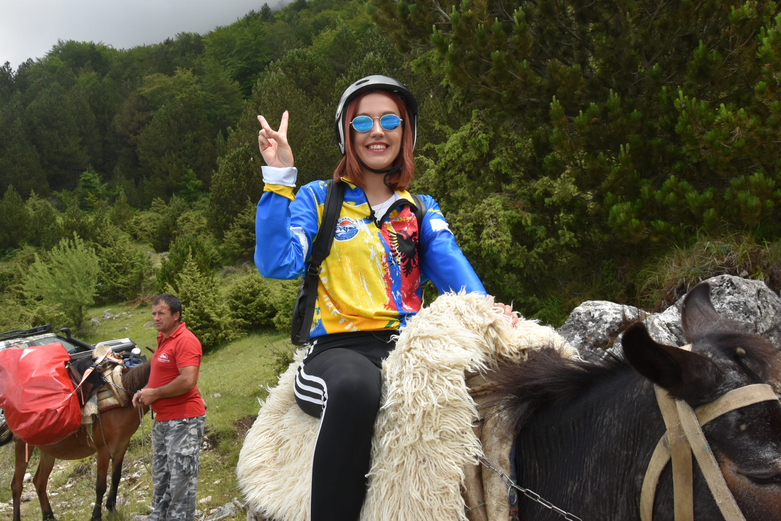 A girl sitting on a mule while trekking on Mount Tomorr in Albania