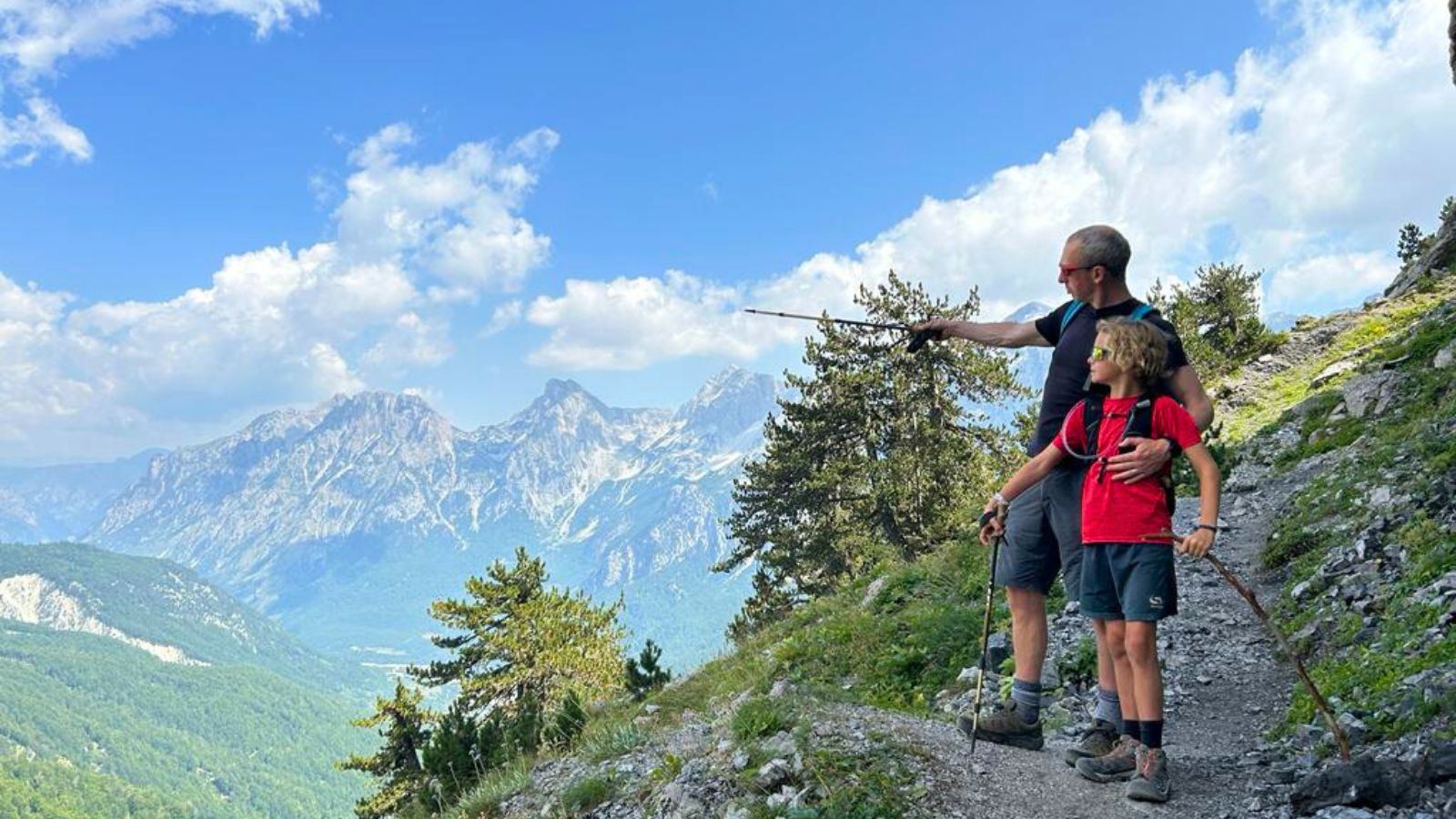 Dad and son admire the view from a hiking trail in the Accursed Mountains