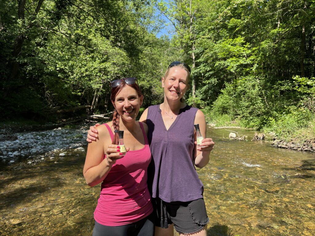 Adventure travel for solo travellers. Carly and her friend Dawn enjoying a rakija during a river hike in Serbia.