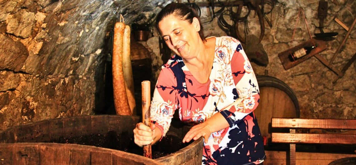 UB's friend Tanya stirs grapes in a wine cellar in Montenegro