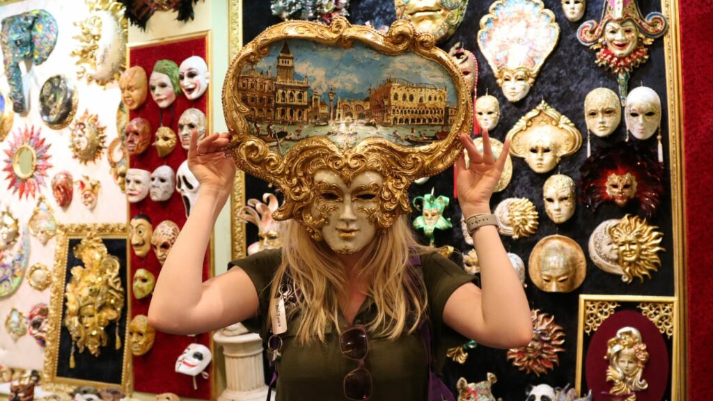 Guest Laura holds one of the Venetian masks up to her face at the workshop in Rozafa Castle, Shkodër, Albania.