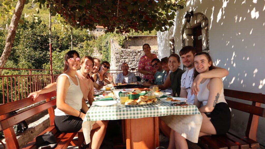 Couples adventure holiday. This group of couples are enjoying a freshly prepared meal at a local family home.