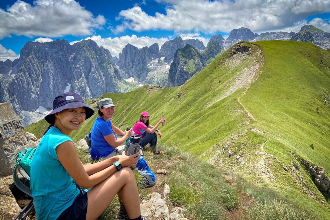 Hikers happy to reach a mountain peak and rest stop in the Balkans on a sunny day