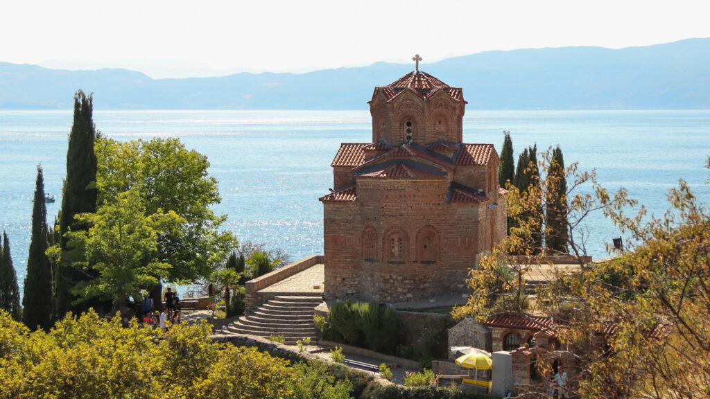 The church of St John at Kaneo with Ohrid lake glistening behind and mountains on the opposite shore