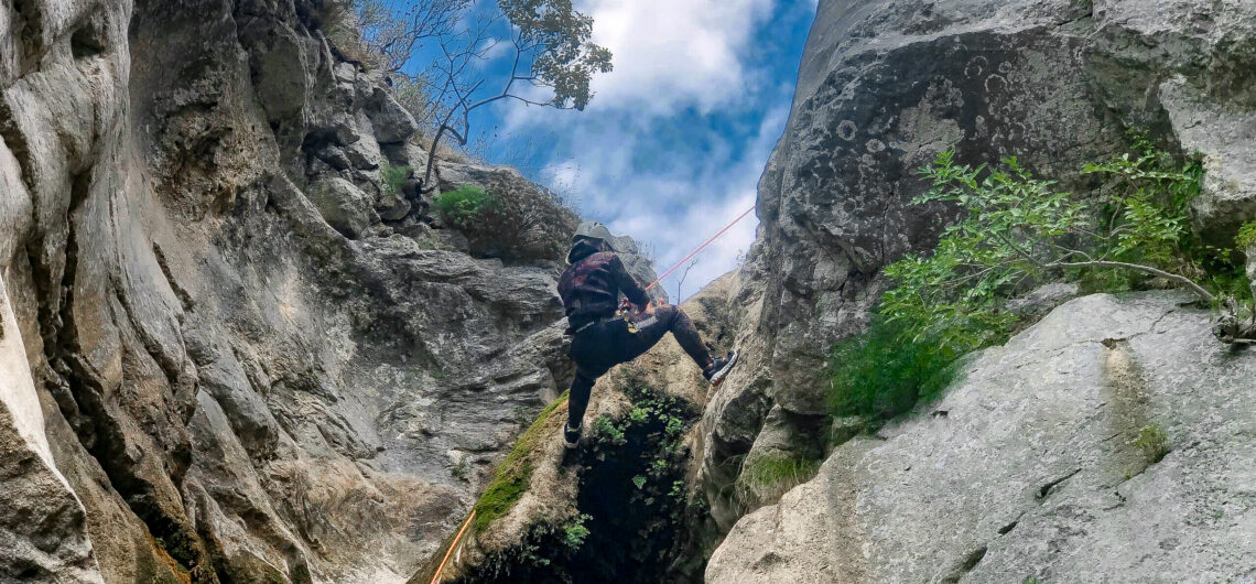 A person abseiling while canyoning in Montenegro on an adventure holiday