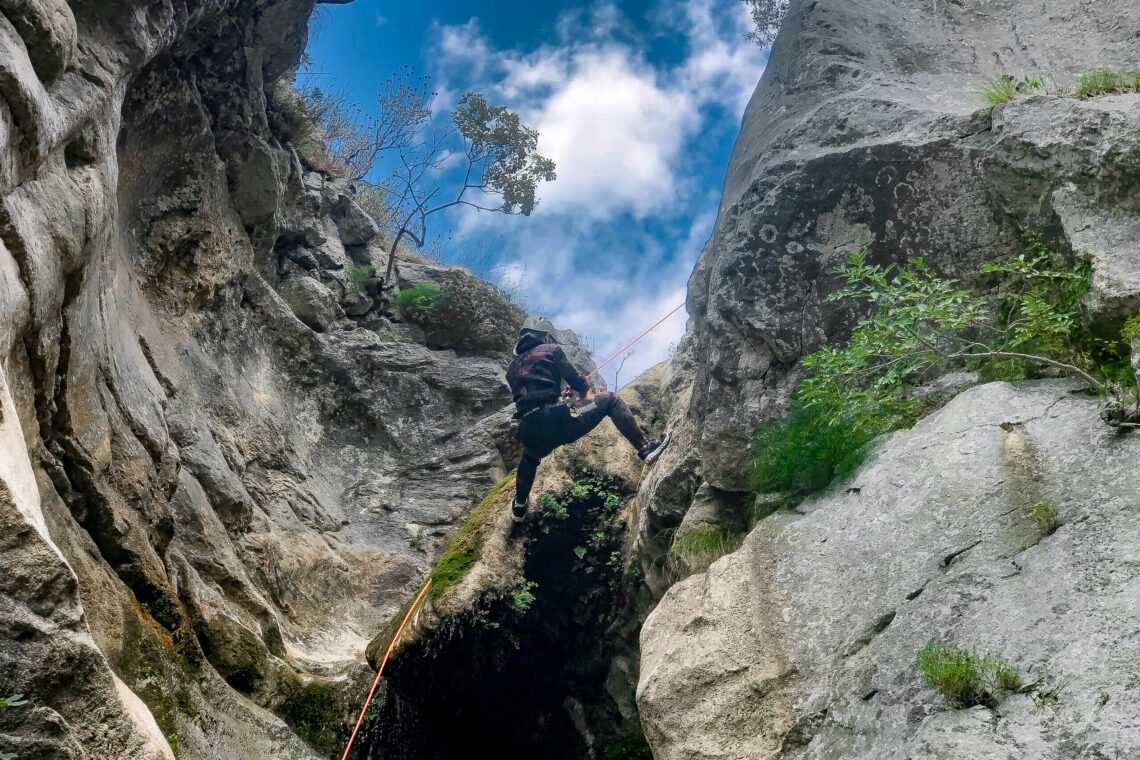 A person abseiling while canyoning in Montenegro on an adventure holiday