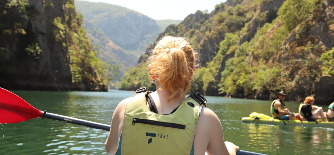 A young girl sitting in a kayak on a family holiday in North Macedonia.
