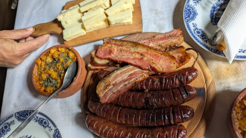 Balkan tradition is to serve extremely large portions like this platter full of homemade sausages, smoked ham and cheese.