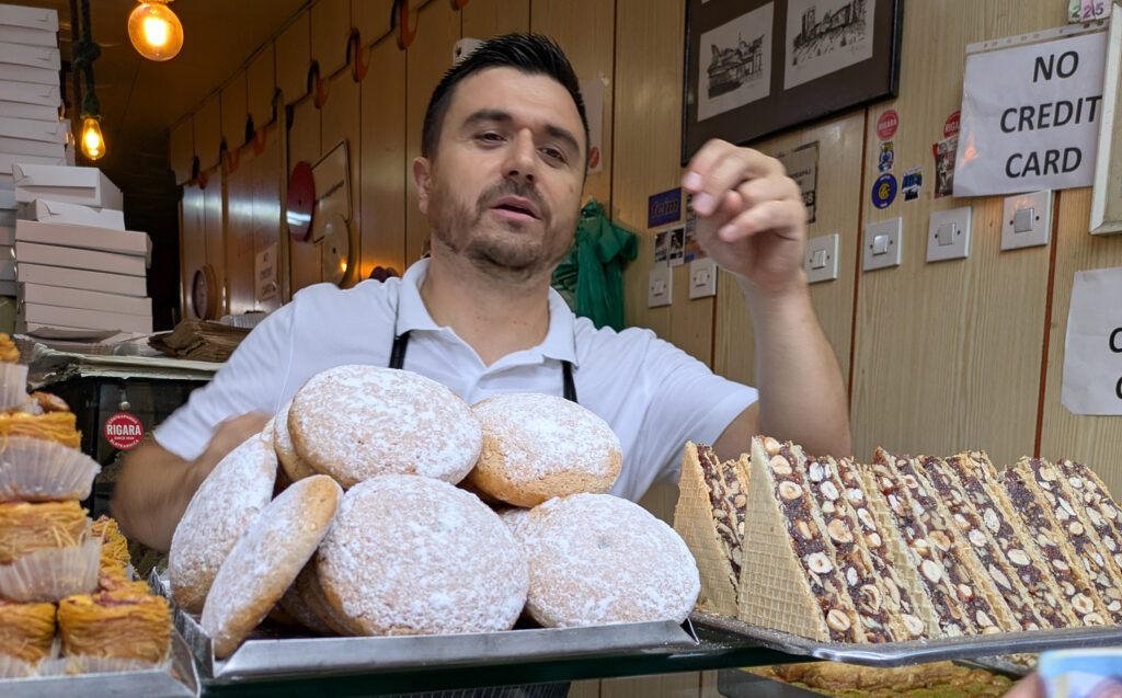 Skopje patisserie owner serving traditional padabranci pastries