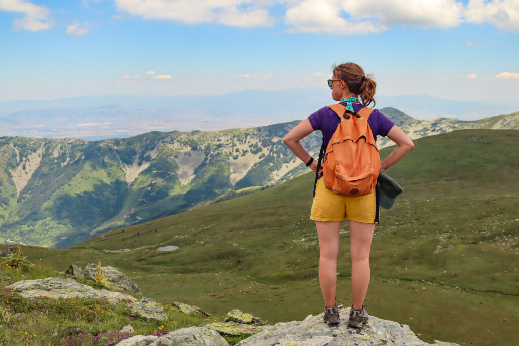 Woman hiking in Pelister National Park, North Macedonia, with mountain views