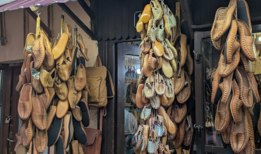 Shopping for handmade leather slippers in Skopje's old bazaar
